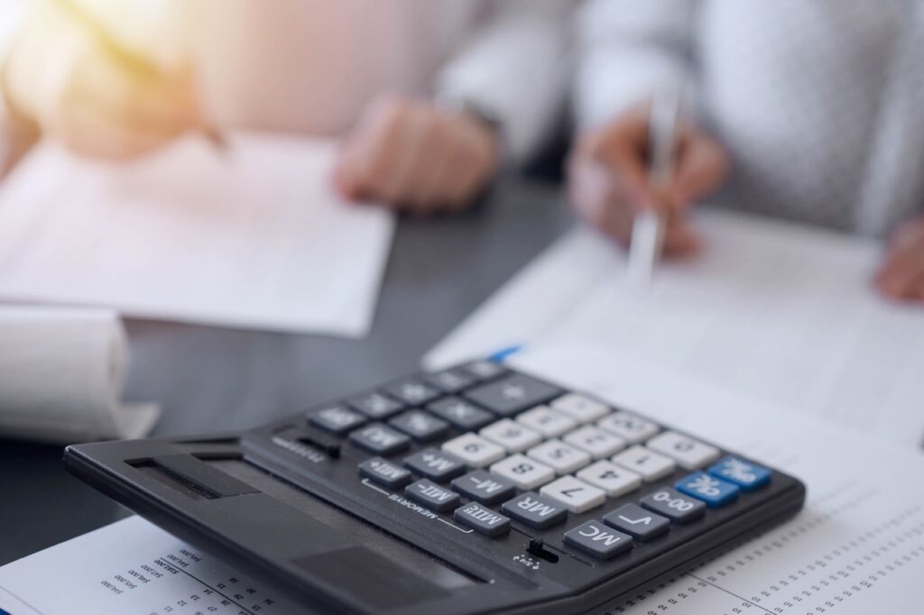 CFO and CX director reviewing customer lifetime value metrics and retention revenue data from contact center analytics platform