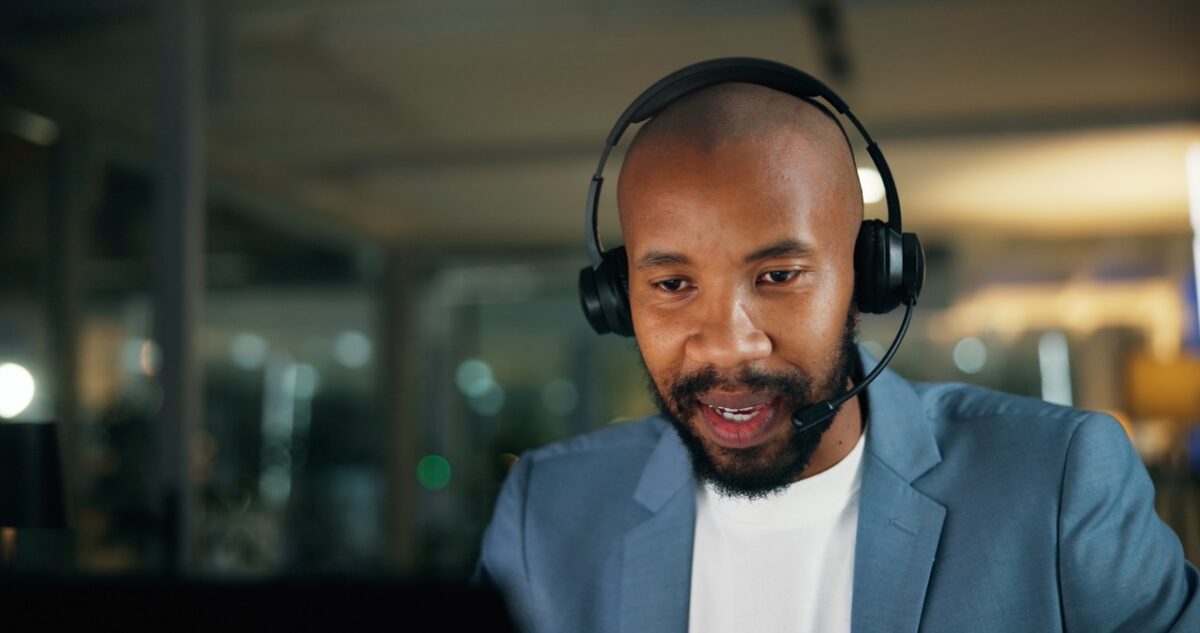 Contact center supervisor reviewing real-time AI sentiment analysis and predictive QA risk flags in ChorusCX dashboard during a live agent call