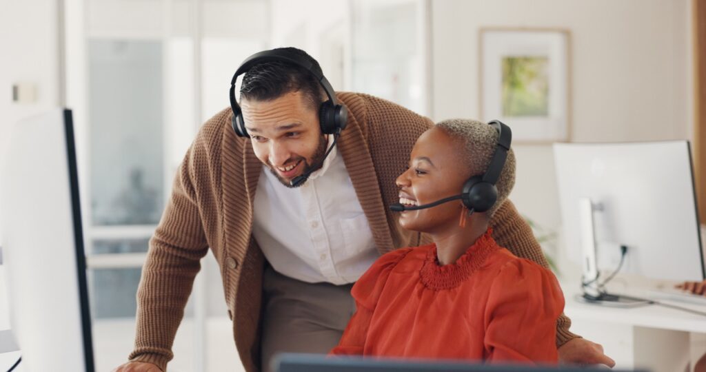 A supervisor coaching an agent using call evidence displayed on a monitor
