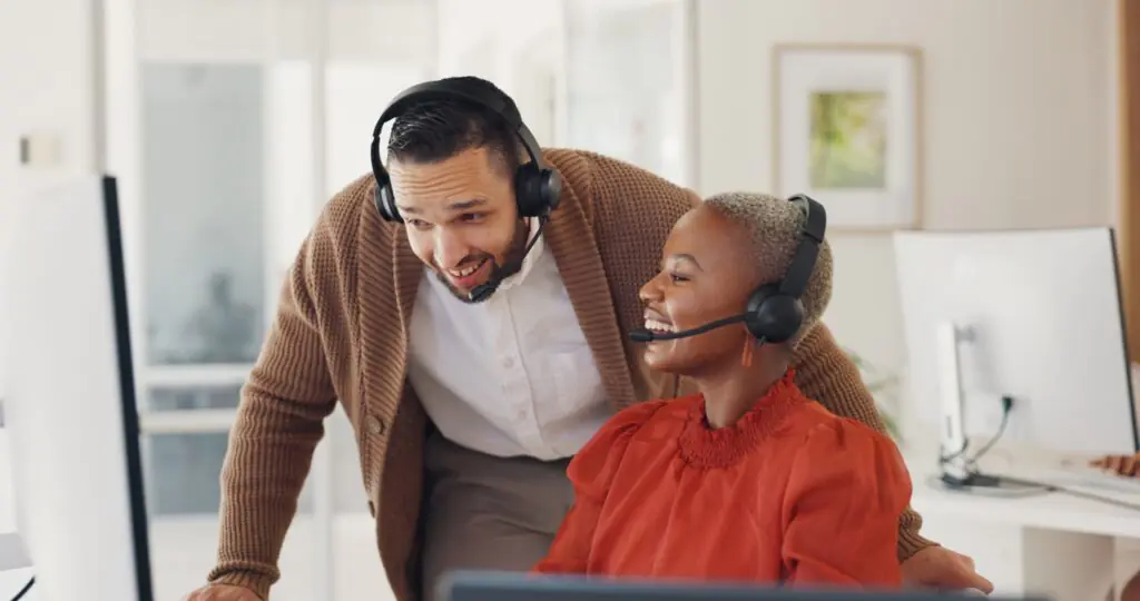 A supervisor coaching an agent using call evidence displayed on a monitor