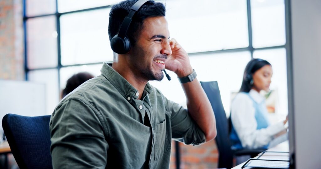 Contact center agent on a call demonstrating behaviors that improve customer outcomes and satisfaction