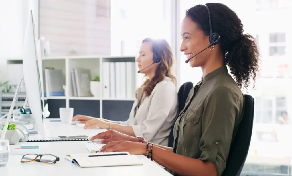 supervisors from two merged contact centers reviewing consolidated QA scoring standards