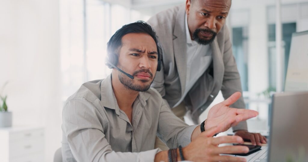 Contact center supervisor coaching an agent using real-time guidance engagement data on a dashboard