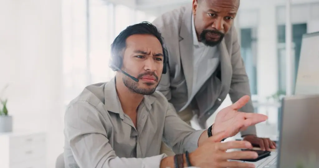 Contact center supervisor coaching an agent using real-time guidance engagement data on a dashboard