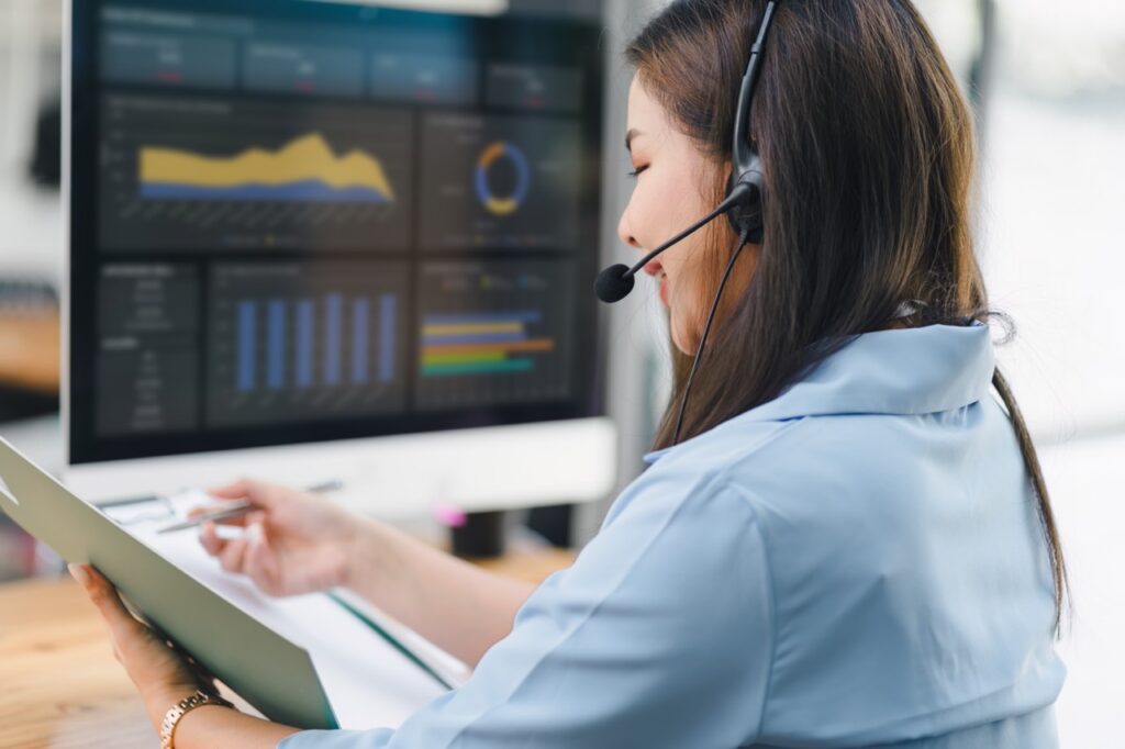 Contact center leader reviewing a monthly QA performance report on a laptop