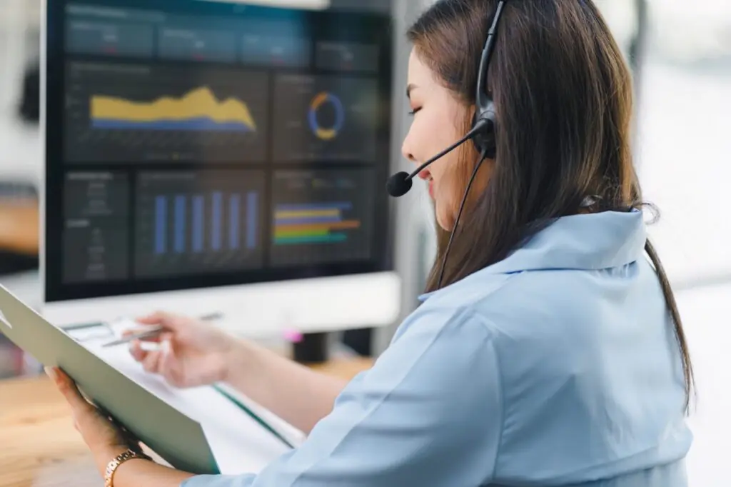 Contact center leader reviewing a monthly QA performance report on a laptop