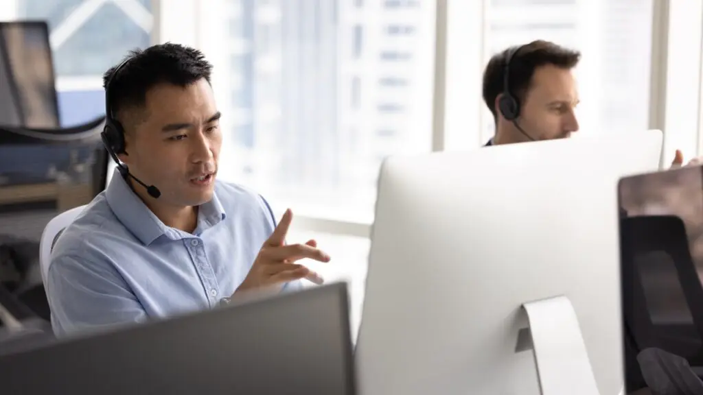 Contact center agent on a call as speech analytics software analyzes sentiment in the opening seconds