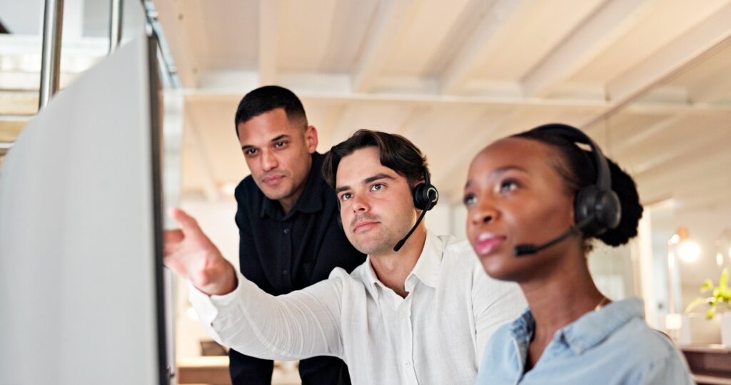 Contact center supervisor reviewing an AI insights dashboard showing quality and compliance scores