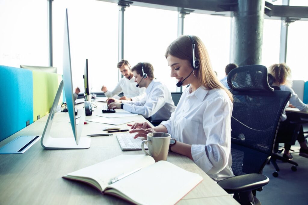 New contact center agent on a headset during her first weeks of onboarding