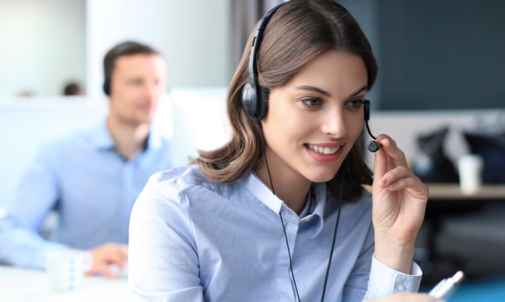Row of contact center agents at their workstations, illustrating workforce management and conversation analytics