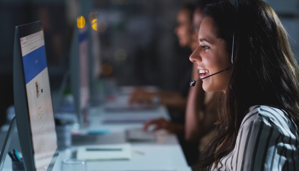 Contact center agent on a headset at her workstation during an interaction recording session