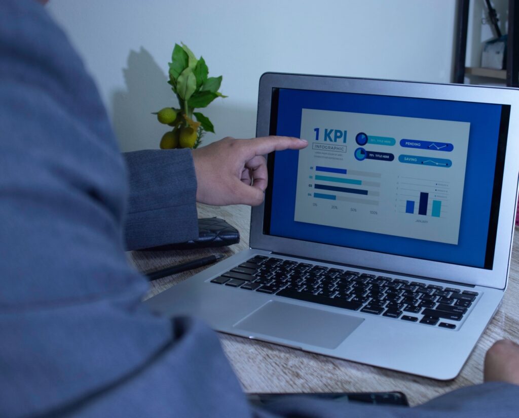 Manager pointing to contact center metrics on a laptop KPI dashboard