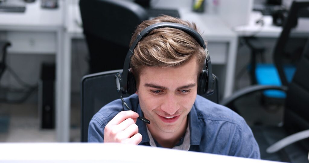 Workforce management analyst reviewing contact center WFM metrics and staffing trends